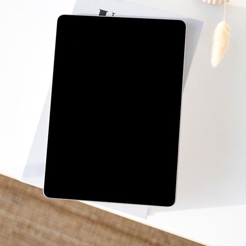 Organized modern workspace with soft blue lighting and a digital tablet